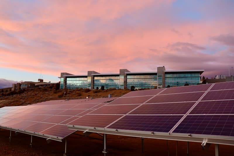 Solar panels in front of a modern commercial building
